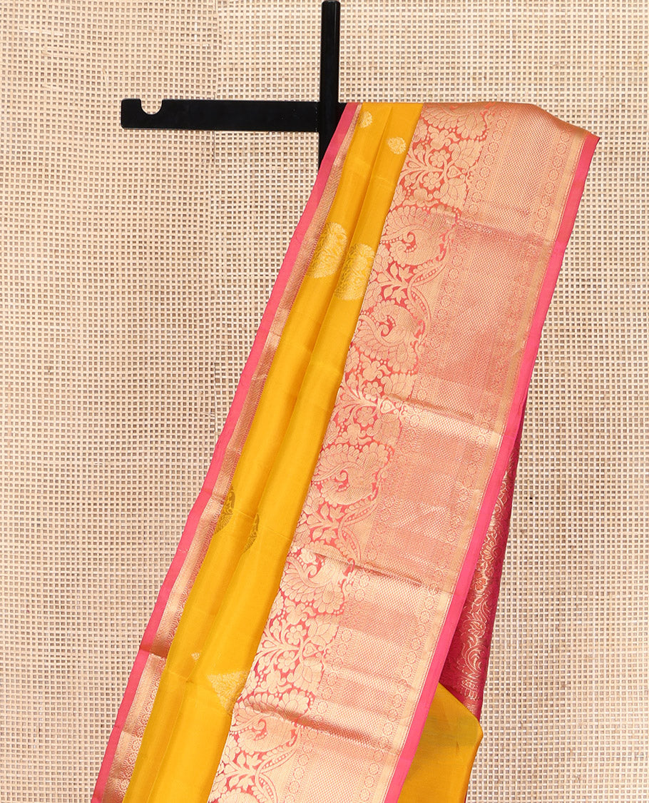 Yellow Vasundhara Lite Silk Mix Saree, Adorned with Zari Buttas All Over Its Body, Complemented by a Contrast Border of Thilakam Mokku, Muthu, Mayil, Kamalam, and Mayil Kann Designs, Gracefully Embellished Pallu, and Paired with a Contrast Blouse