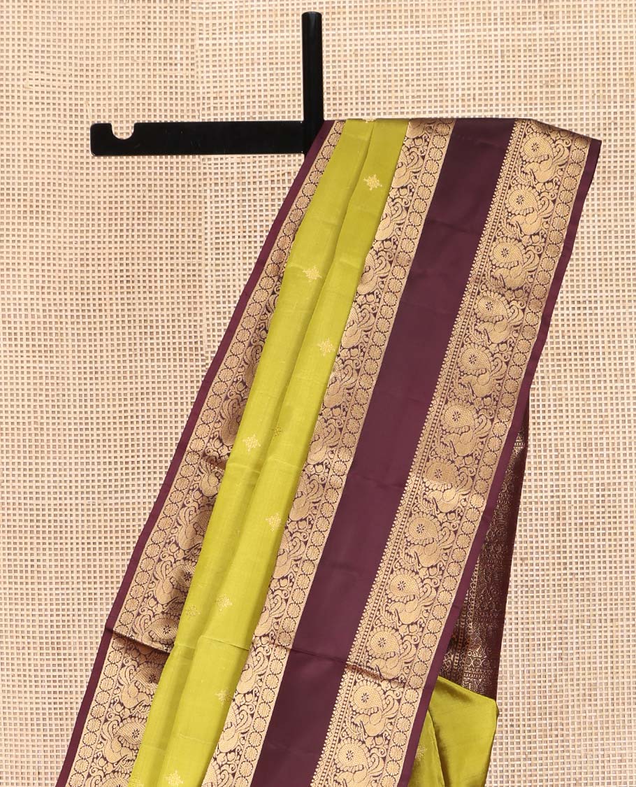 Green Vasundhara Lite Silk Mix Saree, Finely Crafted with Zari Buttas on Its Body, Complemented by Contrast Rettai Pettu Border of Mayil and Laddu Kamalam Designs, Pallu Mirrors the Same Designs, and Paired with a Contrast Blouse