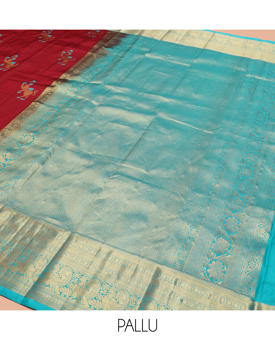 Red Vasundhara Silk Saree, Traditionally Decked up with Navagunjara Buttas, Complemented by a Contrast Border of Rekku, Kathir, Rudraksham, Muthu, and Mayil Designs, Adorned with a Pallu of Jaal Design, and Paired with a Contrast Blouse