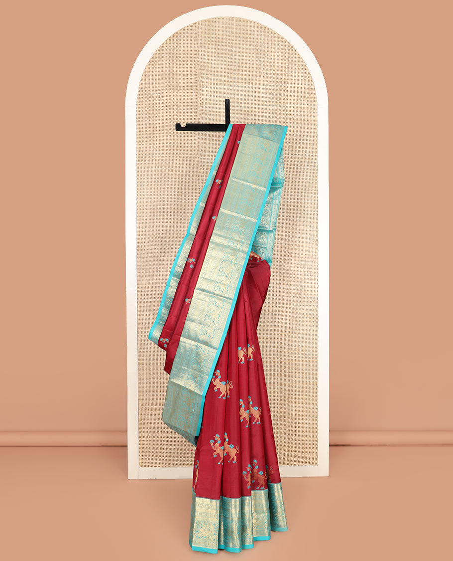 Red Vasundhara Silk Saree, Traditionally Decked up with Navagunjara Buttas, Complemented by a Contrast Border of Rekku, Kathir, Rudraksham, Muthu, and Mayil Designs, Adorned with a Pallu of Jaal Design, and Paired with a Contrast Blouse