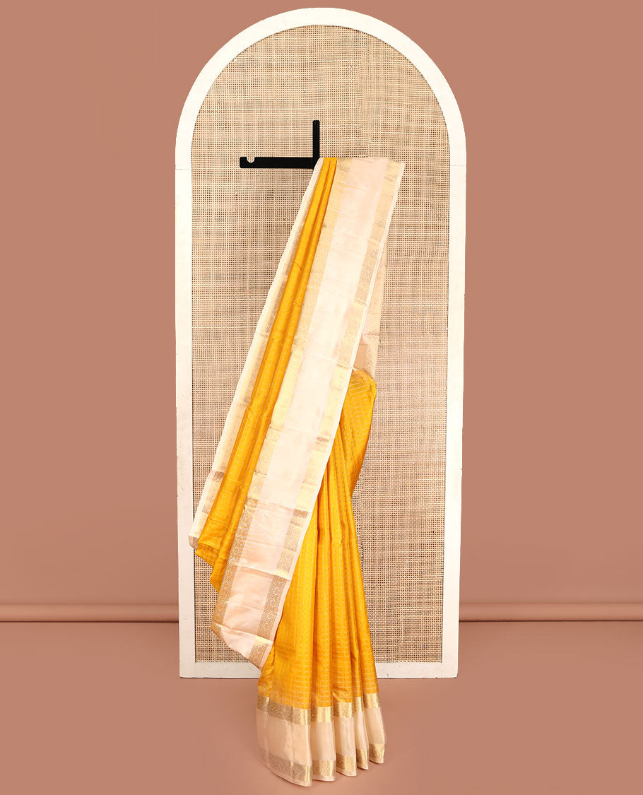 Yellow Vasundhara Silk Saree, Subtly Sparkled with Checked All Over Its Body, Complemented by Contrast Rettai Pettu Border of Thilakam Mokku, and Cross Kamalam Designs, Pallu of Jaal Designs, and Paired with a Contrast Blouse