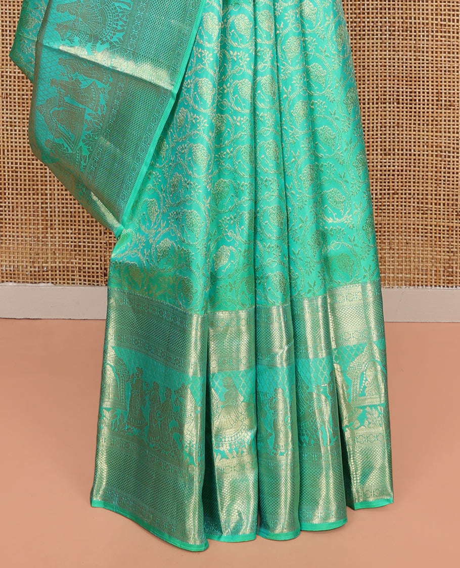 Turquoise Kanchipuram Wedding Silk Saree, Opulently Embellished with Floral Jaal Jacquard Design on Its Body, Highlighted by Zari Border of Diamond, Kuyil Kann, and Wedding-Theme Designs, Grand Jaal Pallu, and Paired with a Matching Blouse