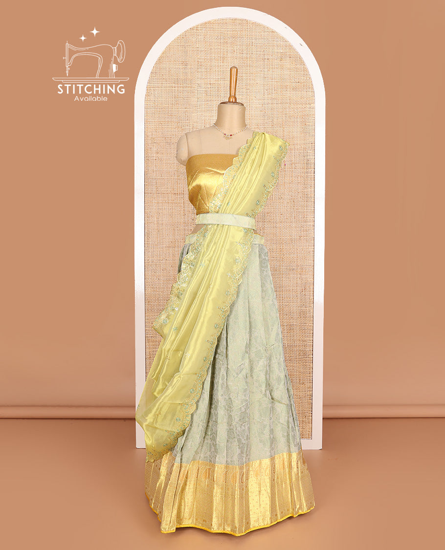 Pastel grey art silk half-saree, floral vine with contrast traditional border skirt, brocade blouse, scallop thread embroidered dhavani, and detachable belt