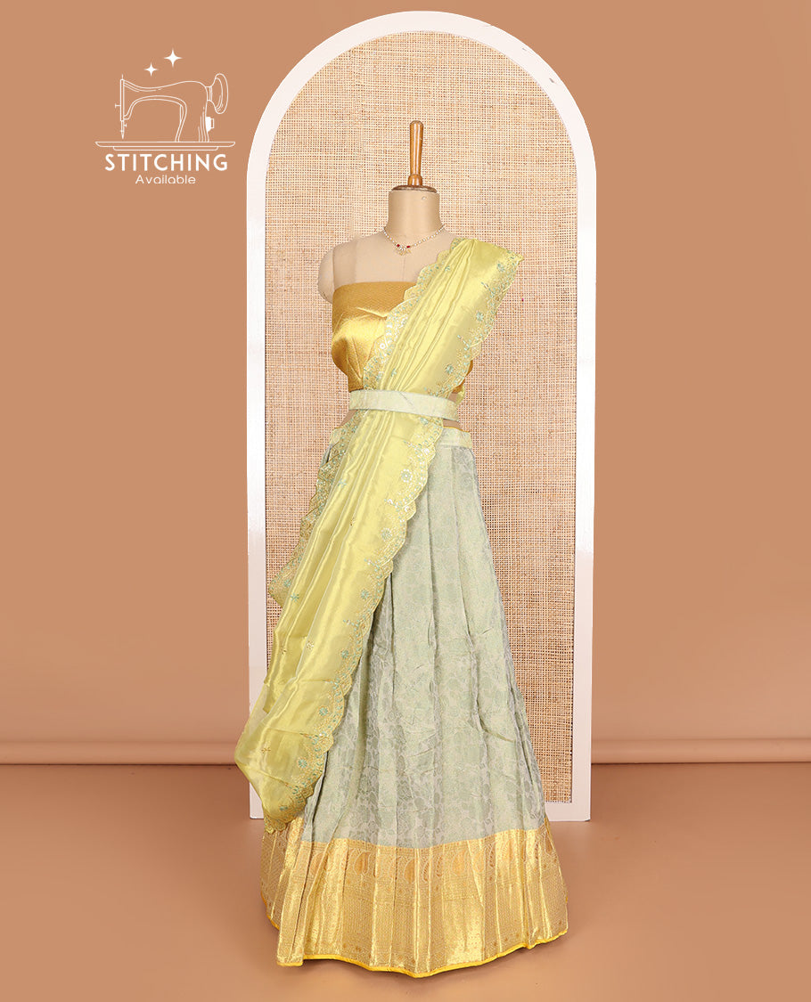 Pastel grey art silk half-saree, floral vine with contrast traditional border skirt, brocade blouse, scallop thread embroidered dhavani, and detachable belt