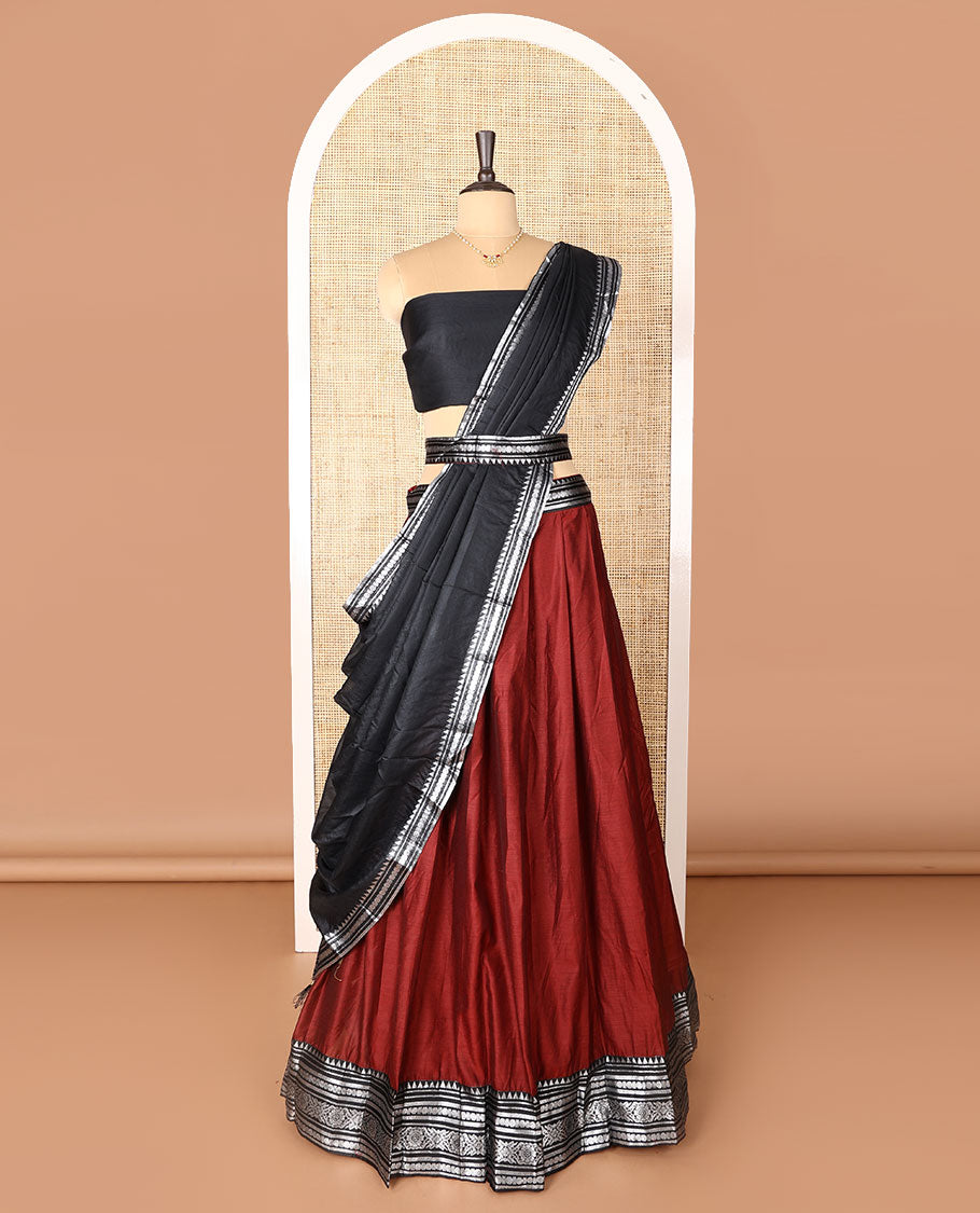 Maroon art-silk half-saree, plain with contrast temple traditional design bordered skirt, contrast blouse, and plain zari bordered dhavani