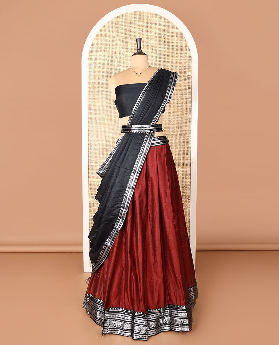 Maroon art-silk half-saree, plain with contrast temple traditional design bordered skirt, contrast blouse, and plain zari bordered dhavani