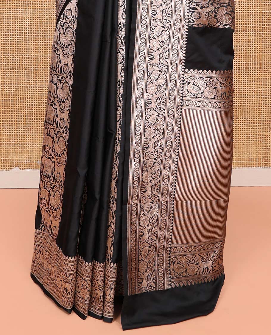 Black Semi-Banaras Silk Saree, Majestically Detailed with Animal-themed Jacquard Designs on Its Body, Highlighted by a Zari Border of Traditional Designs, Pallu Steeped with Stripes, and Paired with a Matching Blouse