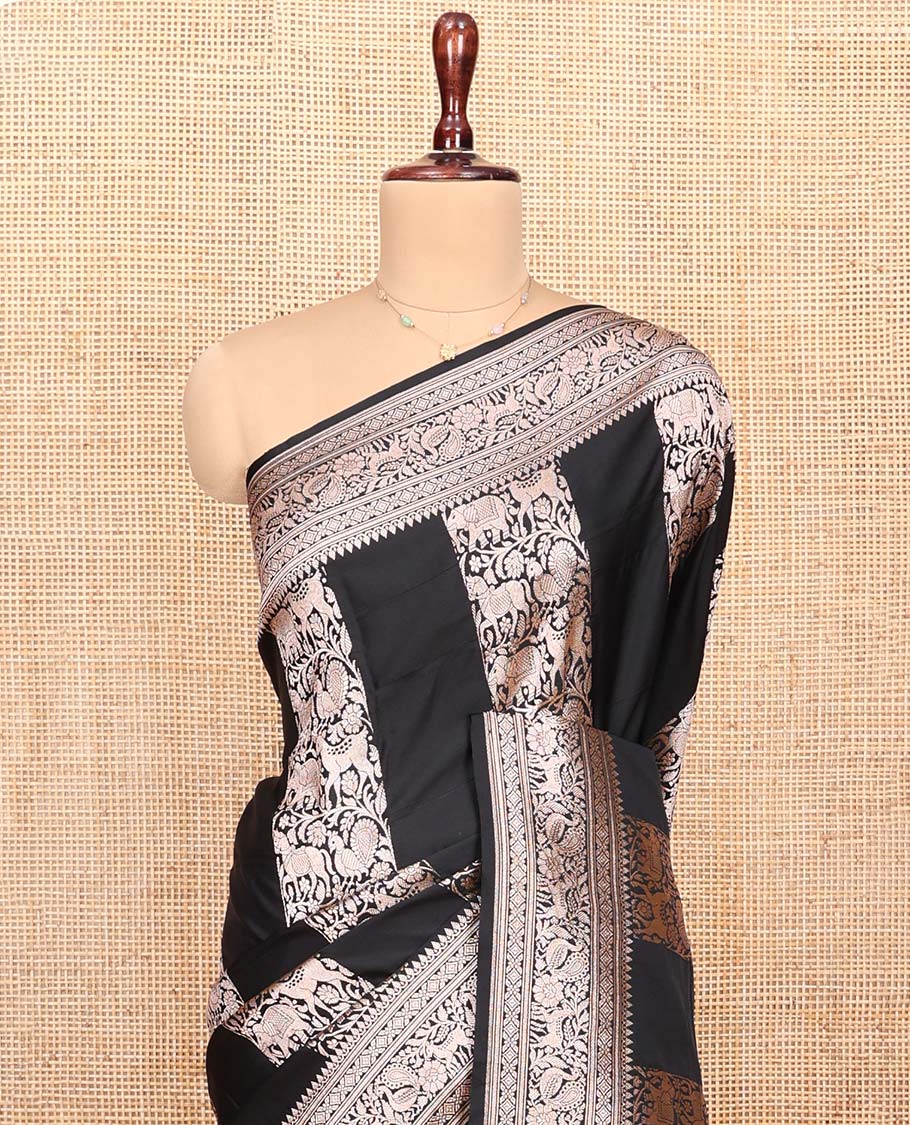 Black Semi-Banaras Silk Saree, Majestically Detailed with Animal-themed Jacquard Designs on Its Body, Highlighted by a Zari Border of Traditional Designs, Pallu Steeped with Stripes, and Paired with a Matching Blouse