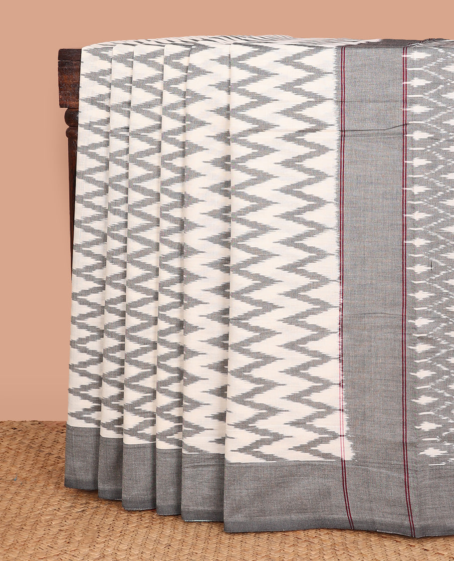 Half-white chevron striped ikkat cotton saree, contrast plain border, and ogee patterned pallu