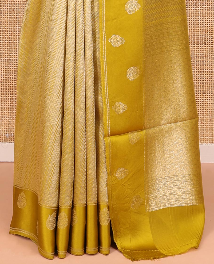 Mustard Russian Dola Silk Saree, Opulently Embellished with Zari Zig-Zag Jacquard on Its Body, Highlighted by Zari Buttas Woven Satin Border, Intricately Designed Pallu, and Paired with a Matching Blouse