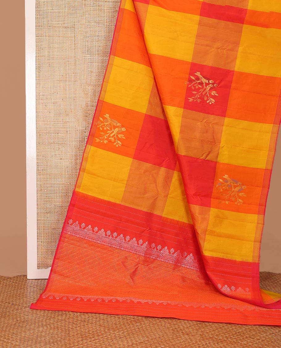 Multi-colored bird buttas enclosed macro-checked Kanchipuram silk saree, striped piping border, and zari-rich pallu