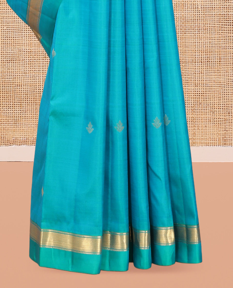 Blue Vasundhara Silk Saree, Subtly Sparkled with Zari Buttas, a Kal Eragina Border of Muthu Designs, Geometric Patterned Pallu, and a Matching Blouse