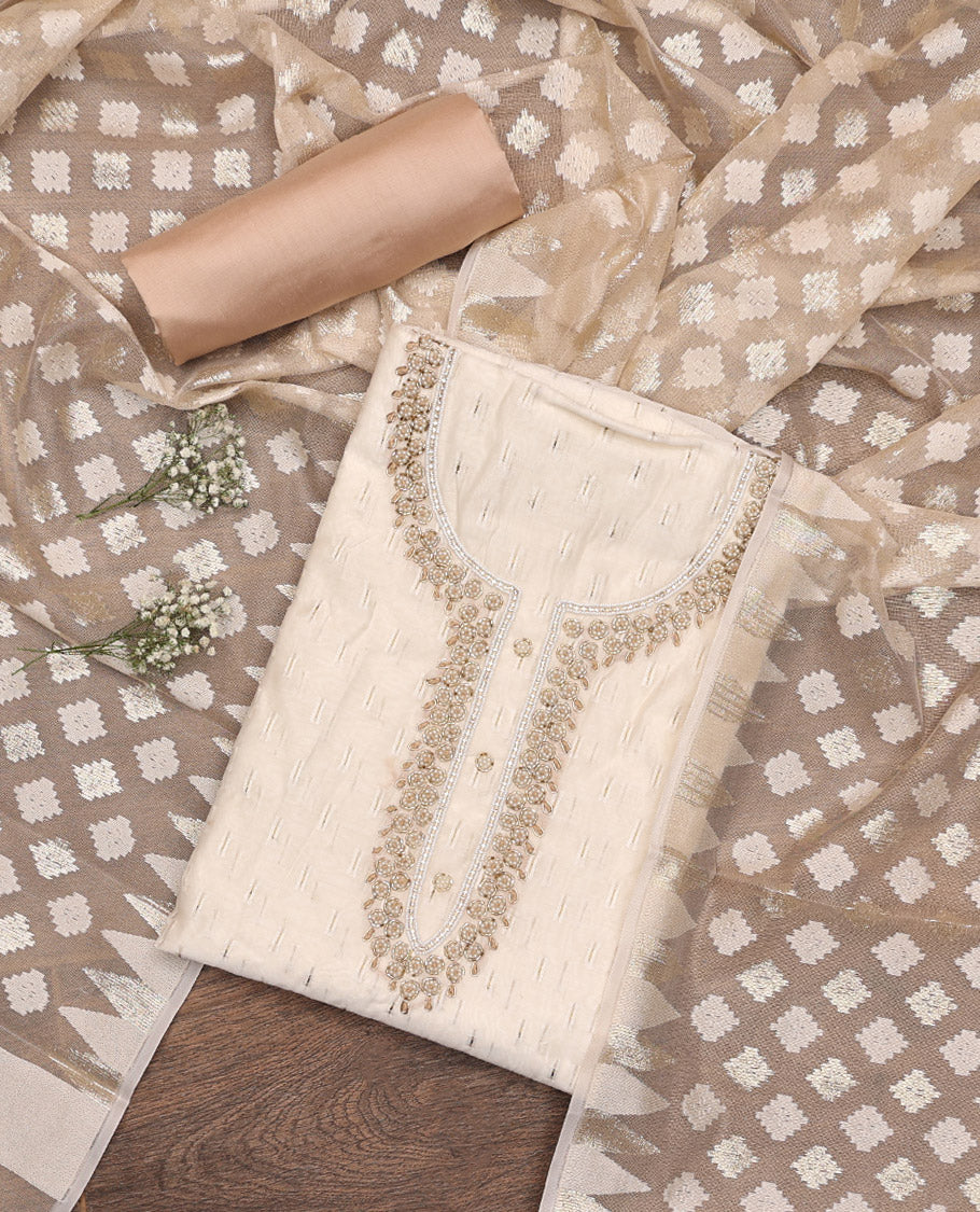 Cream Material Chudidar Set, Subtly Adorned with Sparese Buttas and Embroidery on Tissue Top, a Contrast Santoon Bottom, and Paired with Buttas Steeped Chanderi Silk Dupatta