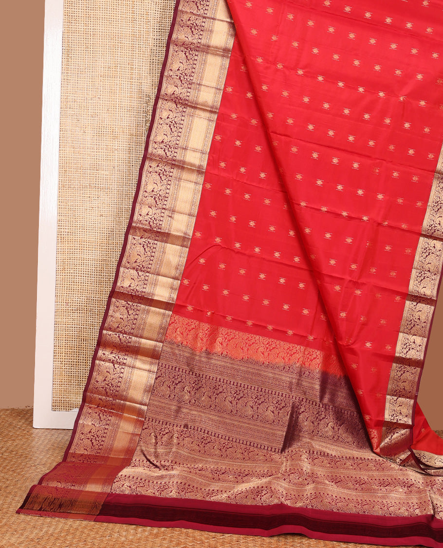 Red zari buttas Vasundhara silk mix saree, contrast border of rekku, laddu kamalam, kuyil kann, rettai neli, poun, and mayil, and intricate pallu