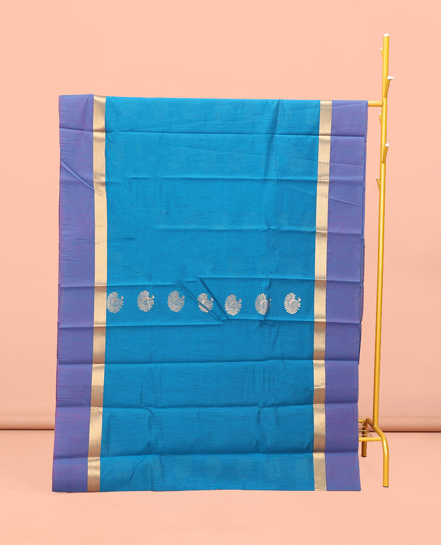Blue Semi-Silk Cotton Saree, Gracefully Embellished with Bird Zari Buttas on Its Body, Complemented by Contrast Border of Peacock Buttas, Pallu Features Peacock Designs, and Paired with a Matching Blouse
