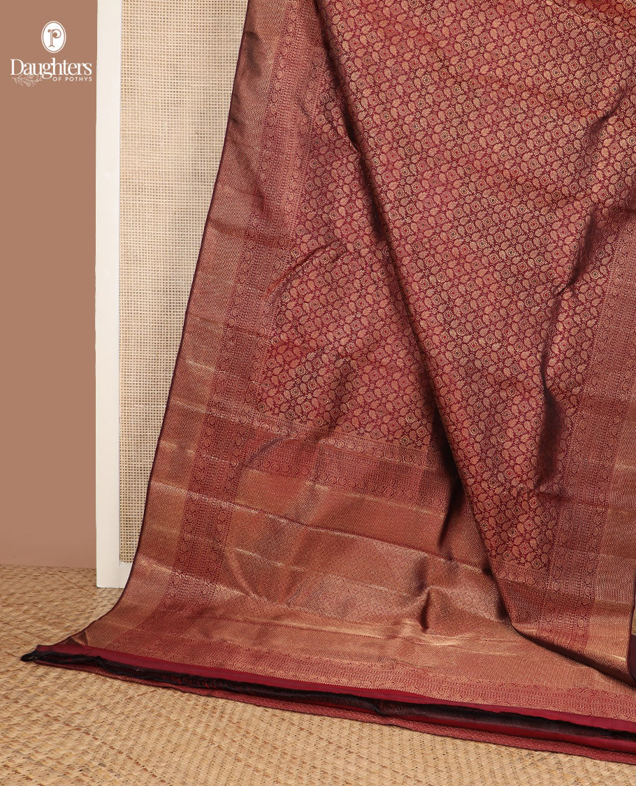 Maroon Jacquard Kanchipuram silksaree,zari border of reeku,paisa,banaras,kodi visiry,neli,manga,lavangam & mayil kann & intricate pallu