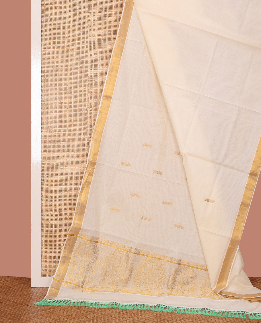 Cream Kerala Cotton Saree Subtly Enriched with Zari Buttas All Over Its Body, Bavanji Border, Charmingly Accented Pallu of Tree Designs, and Paired with a Matching Blouse