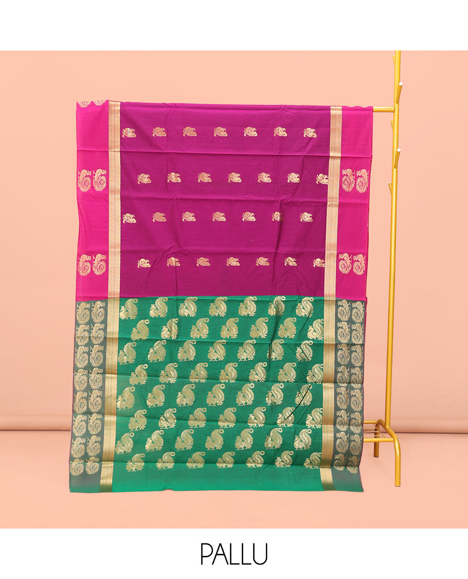 Rani Pink Semi-Silk Cotton Saree, Artfully Designed with Peacock Zari Buttas on Its Body, Complemented by a Contrast Border of Peacock Designs, Pallu Steeped with Peacock Zari Design, and Paired with a Matching Blouse