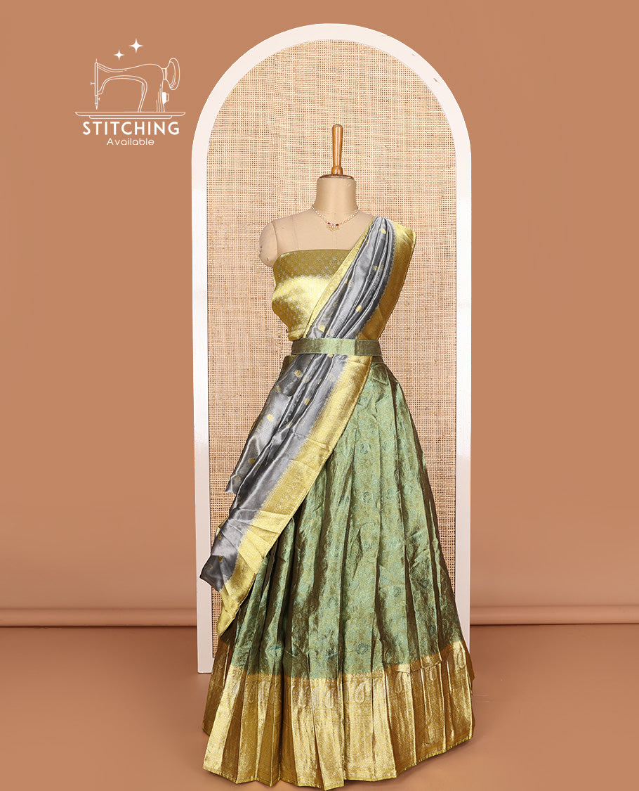 Green art silk half-saree, sparsely design with contrast traditional motifs bordered skirt, contrast blouse, and traditional motif dhavani