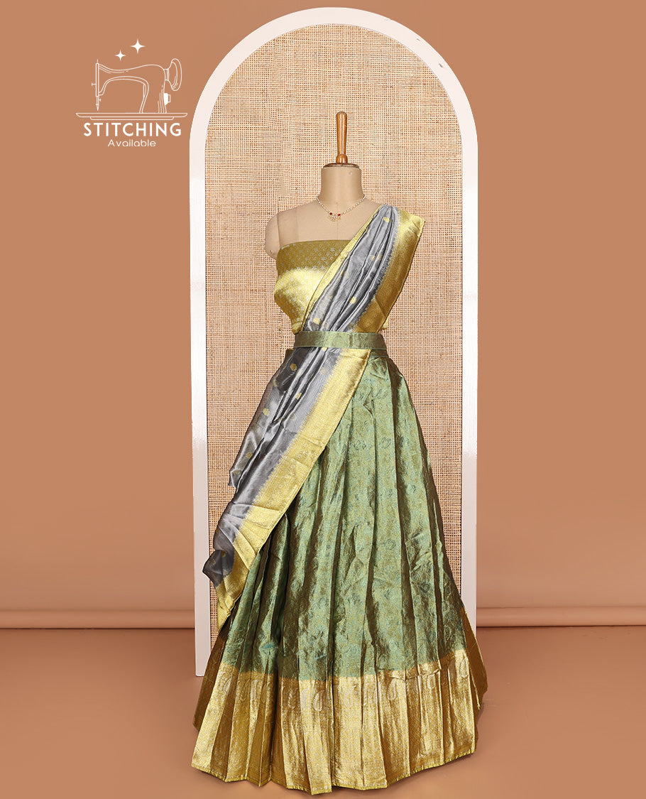 Green art silk half-saree, sparsely design with contrast traditional motifs bordered skirt, contrast blouse, and traditional motif dhavani