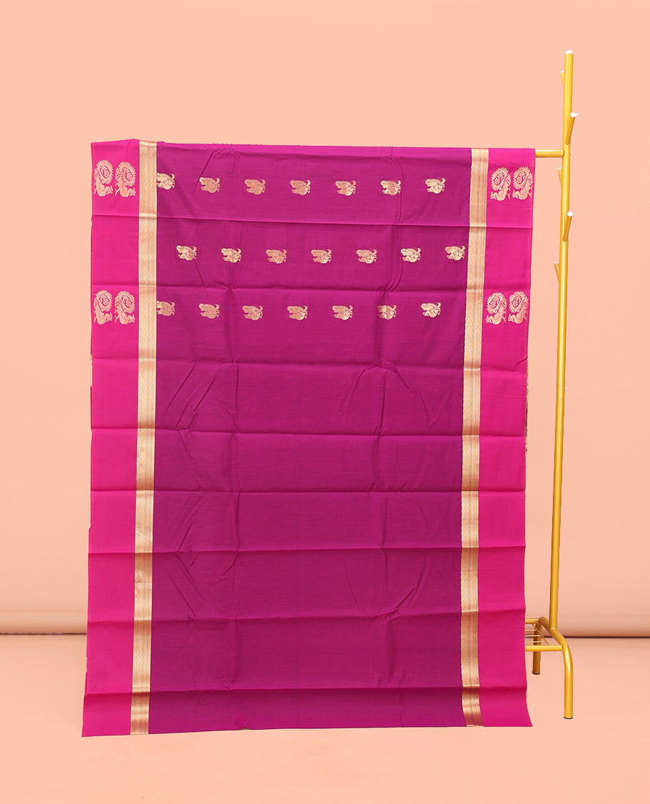 Rani Pink Semi-Silk Cotton Saree, Artfully Designed with Peacock Zari Buttas on Its Body, Complemented by a Contrast Border of Peacock Designs, Pallu Steeped with Peacock Zari Design, and Paired with a Matching Blouse