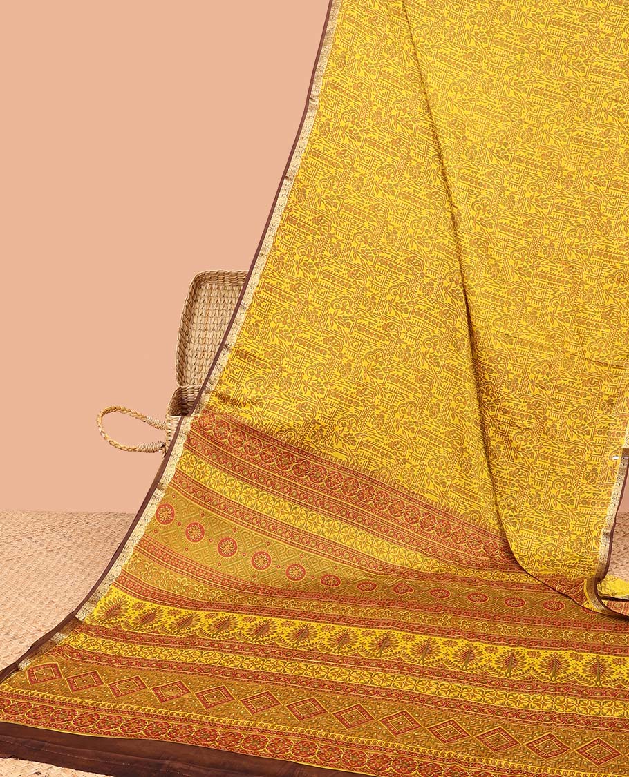 Yellow intricately printed semi-banaras printed saree, contrast zari border & intricate pallu