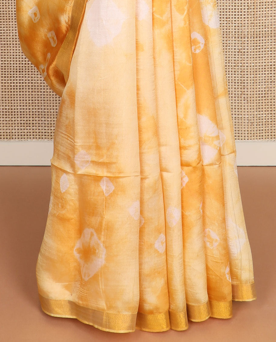 Yellow shibori motifs printed Banana pith saree, golden zari bavanji border, and pallu steeped with sparse gold lines