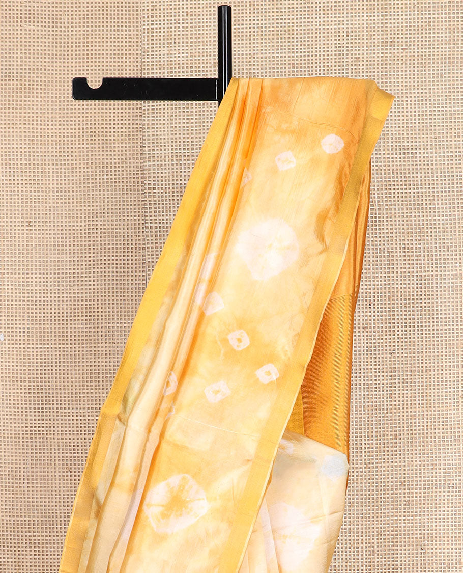 Yellow shibori motifs printed Banana pith saree, golden zari bavanji border, and pallu steeped with sparse gold lines