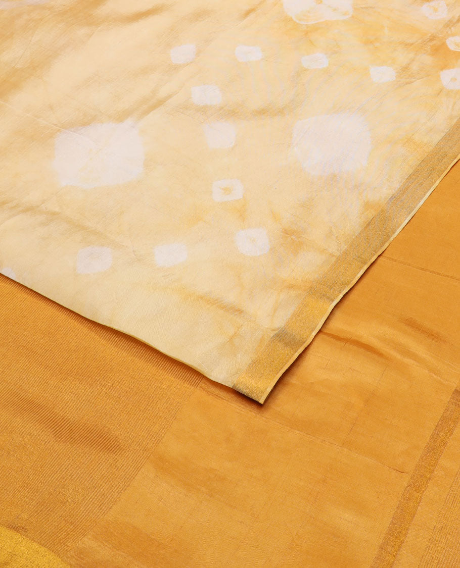 Yellow shibori motifs printed Banana pith saree, golden zari bavanji border, and pallu steeped with sparse gold lines