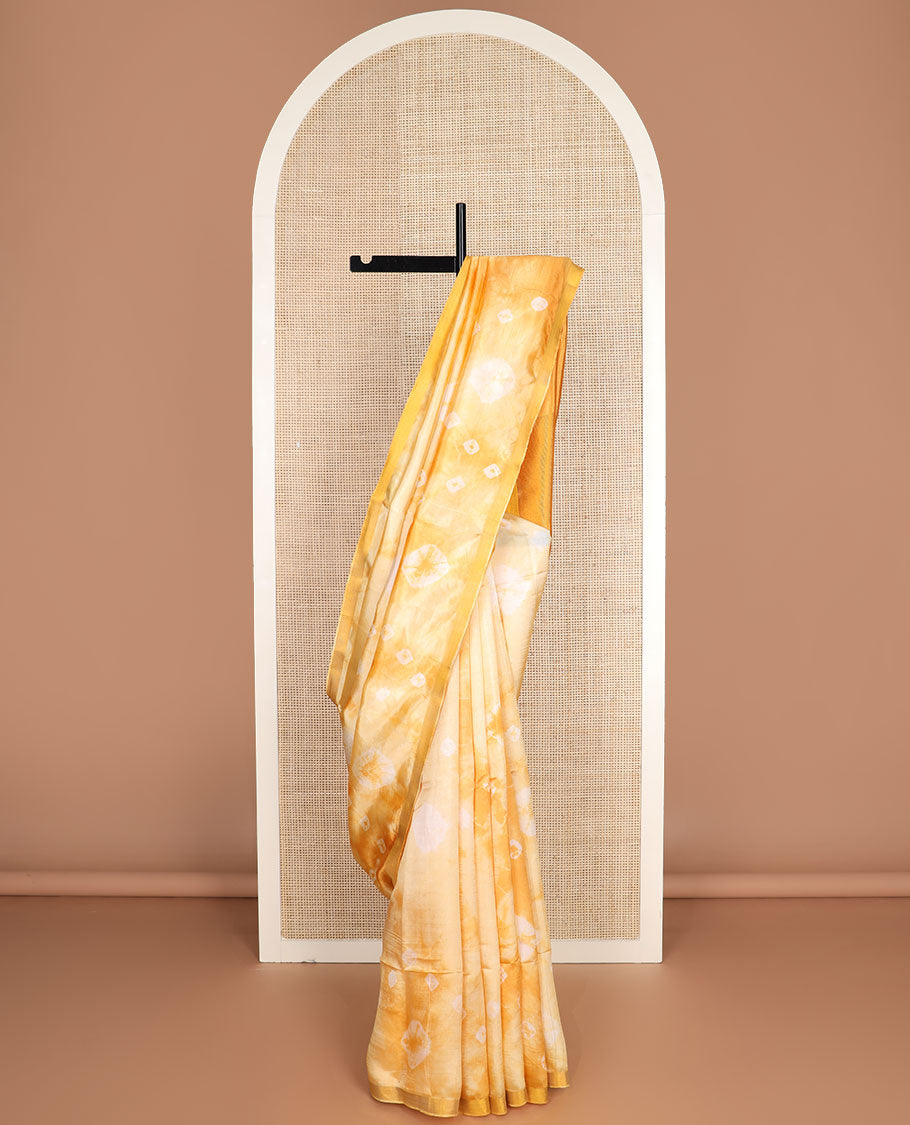 Yellow shibori motifs printed Banana pith saree, golden zari bavanji border, and pallu steeped with sparse gold lines