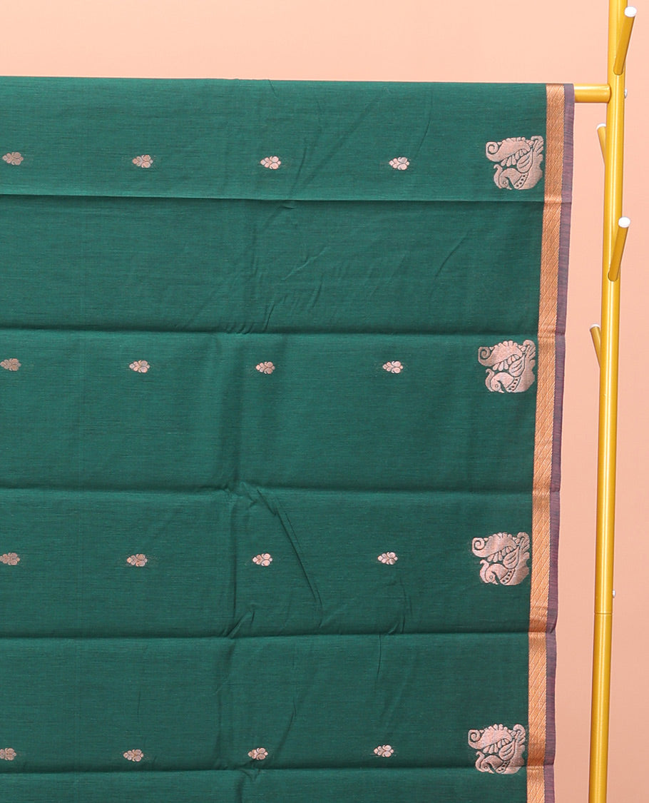 Bottle Green Semi-Silk Cotton Saree, Impeccably Designed with Peacock Zari Buttas on Its Body, Complemented by a Contrast Border of Peacock Designs, Pallu Steeped with Peacock Zari Design, and Paired with a Matching Blouse