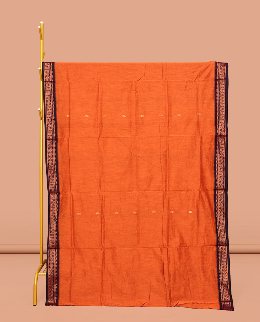Orange Kalyani Cotton Saree, Graced with Buttas All Over Its Body, Complemented by a Contrast Traditional Zari Design Border, Pallu Features Traditional Zari Designs, and Paired with a Contrast Blouse