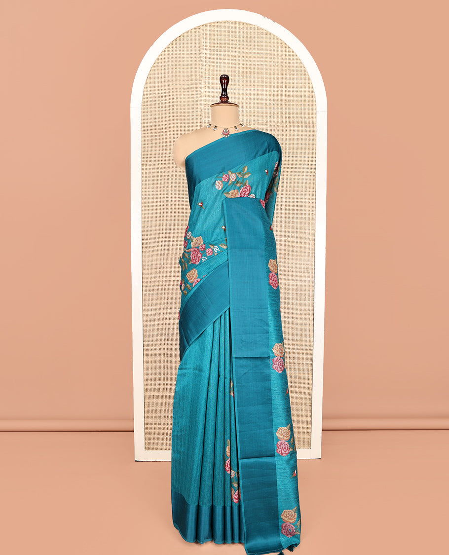 Rama Blue Green-Silk Saree, Colorfully Highlighted with Rose Motifs Cross Stitch Embroidery on Its Body, Subtly Sparkled by a Plain Border, Pallu of Rose Cross Stitch Embroidery, and Paired with a Contrast Blouse