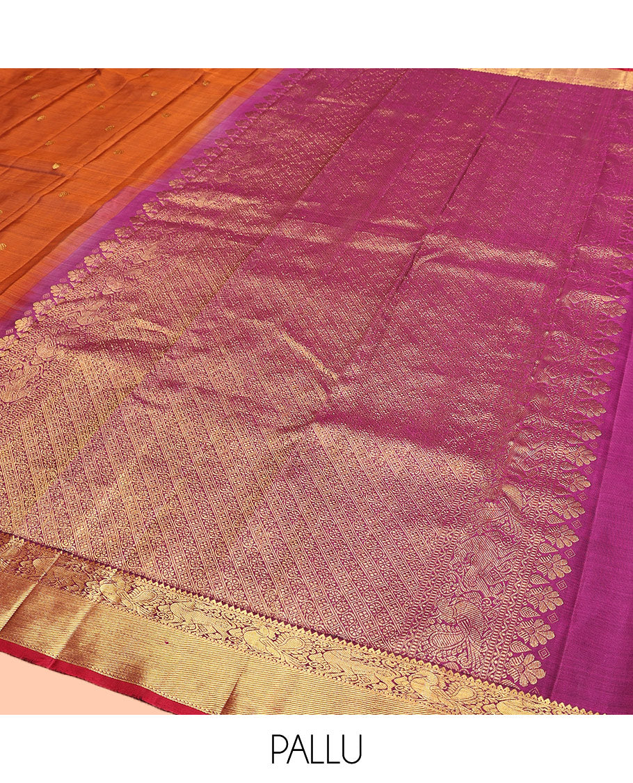 Orange Kanchipuram Silk Saree, Detailed with Chakram Buttas All Over Its Body, Complemented by Contrast Border of Rekku, Muthu, Mayil, and Yaali Designs, Pallu of Kodi Visiry and Lavangam Designs, and Paired with a Contrast Blouse