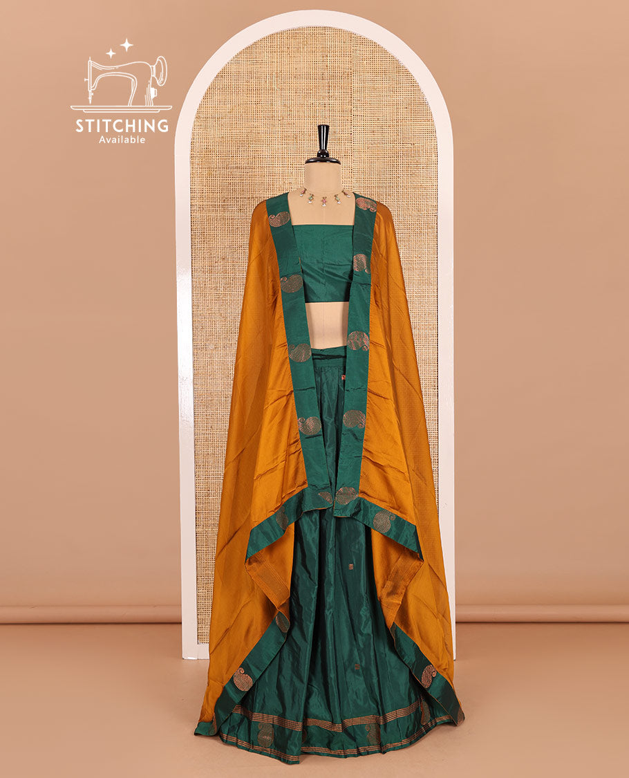 Green half-saree, buttas with self-bordered taffeta silk skirt, a plain blouse, and a contrast manga buttas bordered satin georgette dhavani