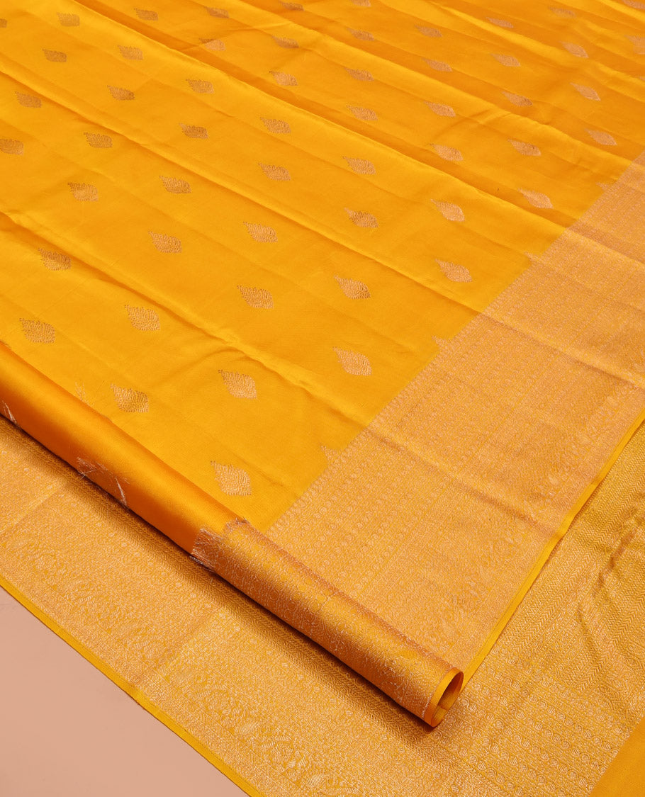 Yellow Kanchipuram Silk Saree, Subtly Sparkled with Zari Buttas All Over Its Body, Highlighted by a Zari Traditional Design Border, Grand Pallu, and Paired with a Matching Blouse
