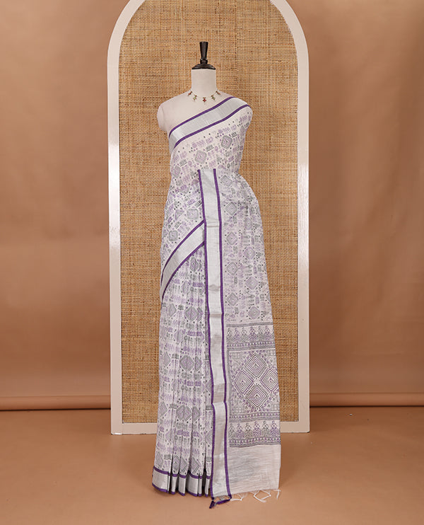 White with violet vareli pattern printed design linen with silver zari bawanchi border & printed pallu with tussels