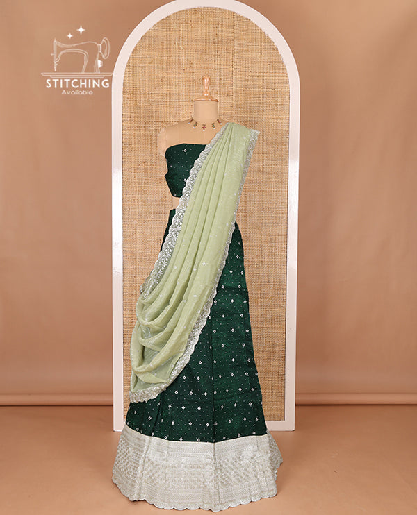Green half-saree, floral motifs embroidered semi raw silk top, matching embroidered blouse, and contrast scallop embroidered georgette dhavani