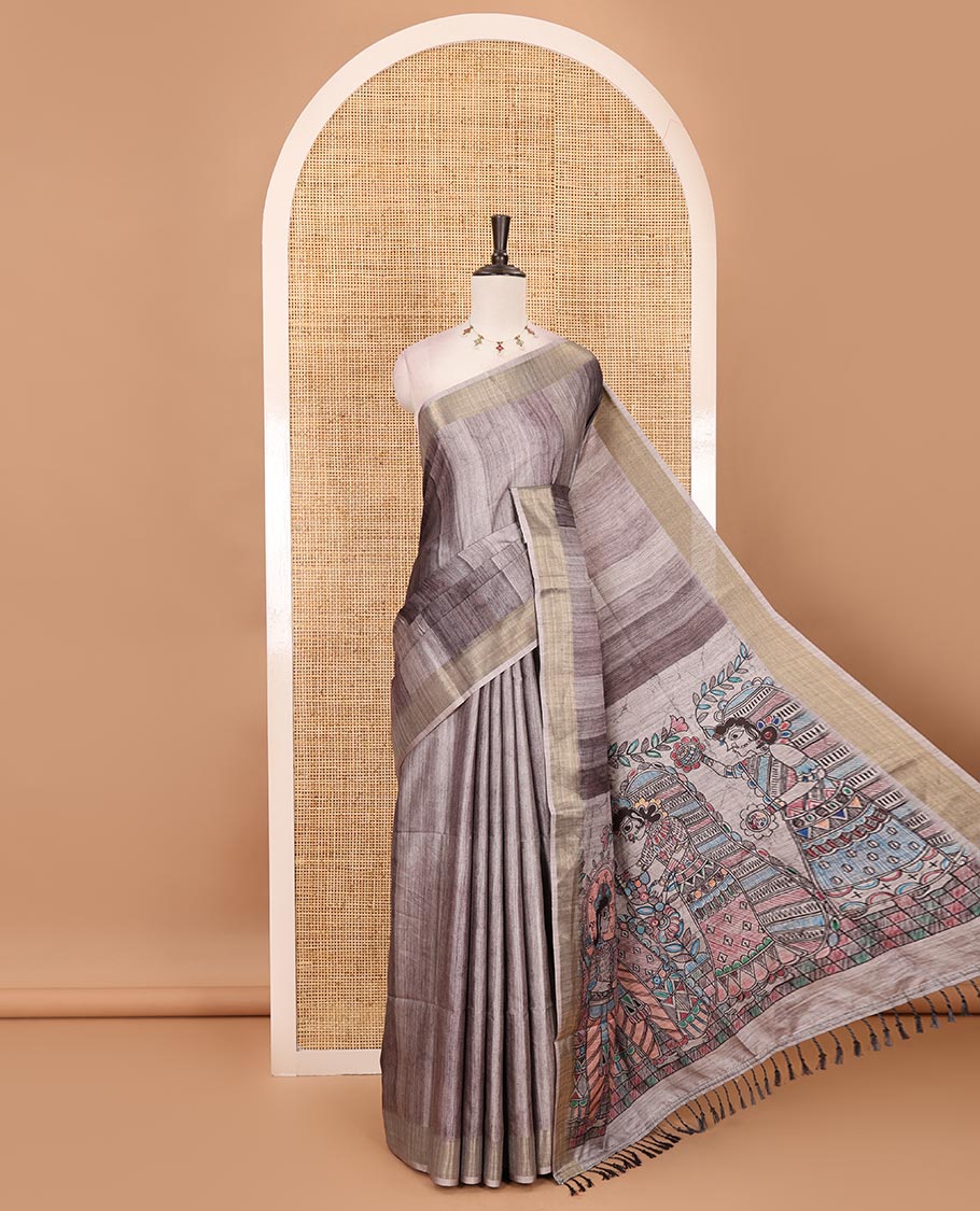 Black vertical stripes printed hand-brush dyed Katan silk saree, gold zari bavanji border, Madhubani-style human figurines printed pallu, and floral printed blouse