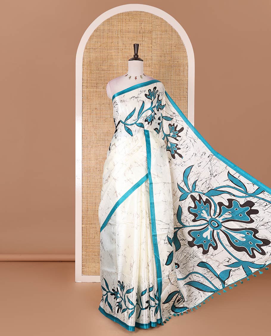 Half-white batik-style floral vine printed khadi cotton saree, contrast rama blue border, batik floral printed, and contrast flower motifs printed blouse