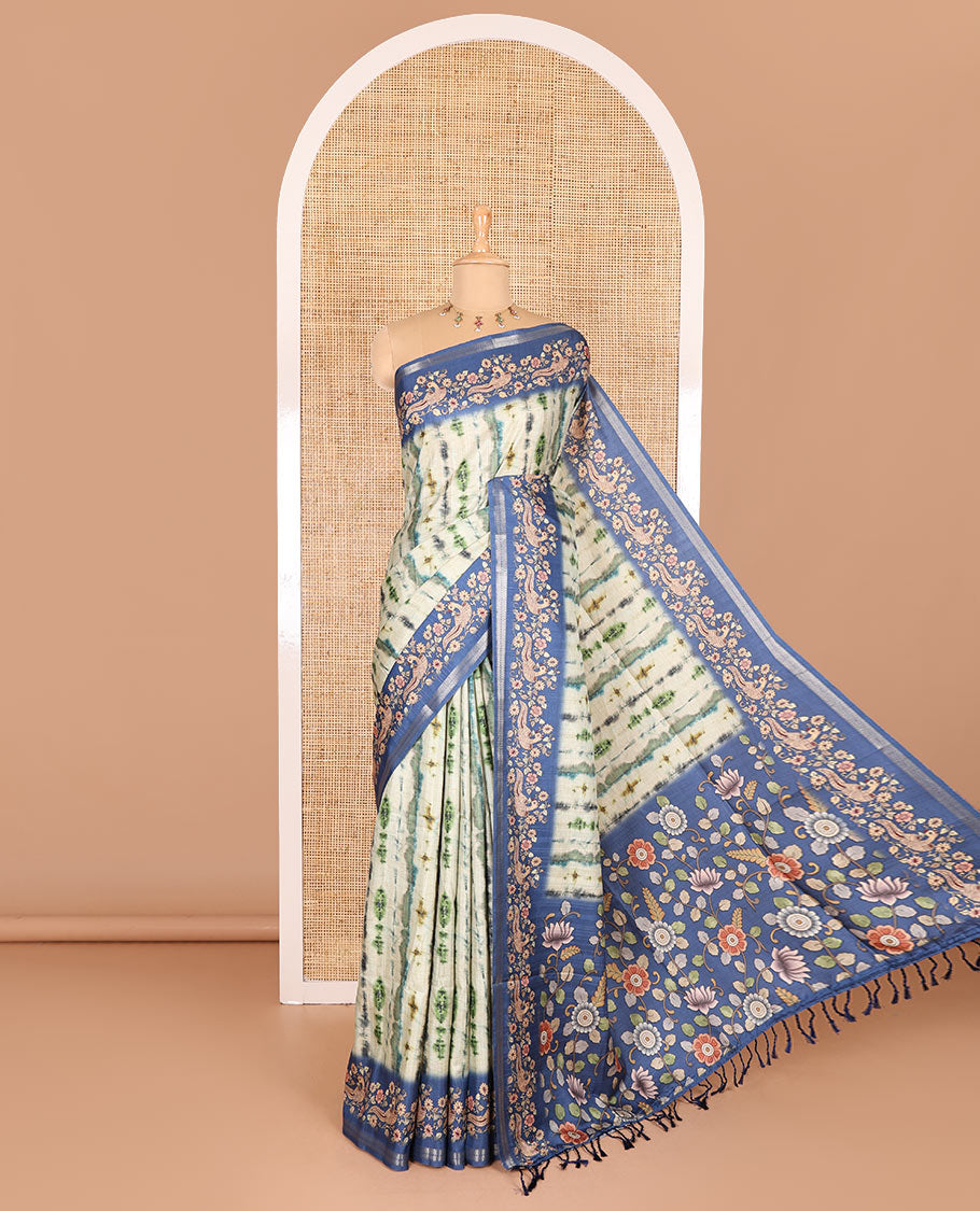 Green shibori printed katan silk saree, contrast border, and pallu of kalamkari floral vine and peacock print, and a contrast leaf printed blouse
