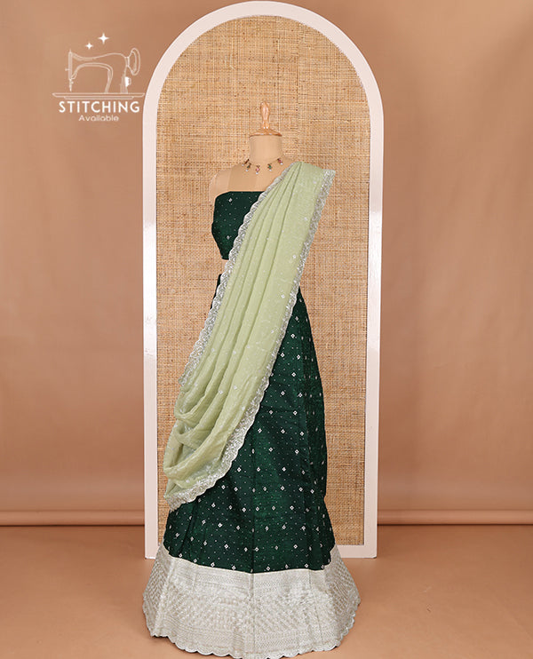 Green half-saree, floral motifs embroidered semi raw silk top, matching embroidered blouse, and contrast scallop embroidered georgette dhavani