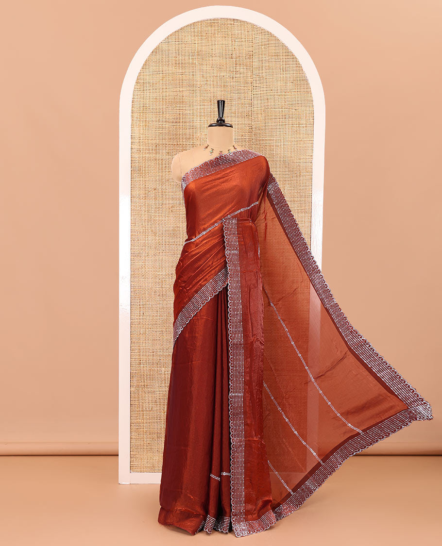 Rust color horizontally swarovski stone striped fendi chiffon saree, swarovski stone work border, and a plain blouse