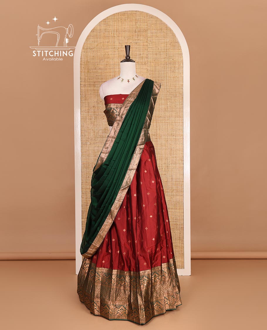 Maroon taffeta silk half saree, zari buttas with contrast green traditional zari border skirt, matching zari design blouse, and contrast plain zari border syska georgette dhavani