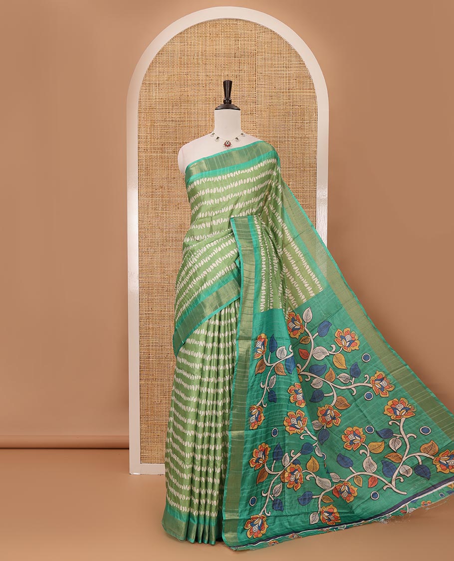 Green uniquely printed soft tussar saree, contrast zari border, kalamkari floral vine printed pallu & kalamkari printed blouse