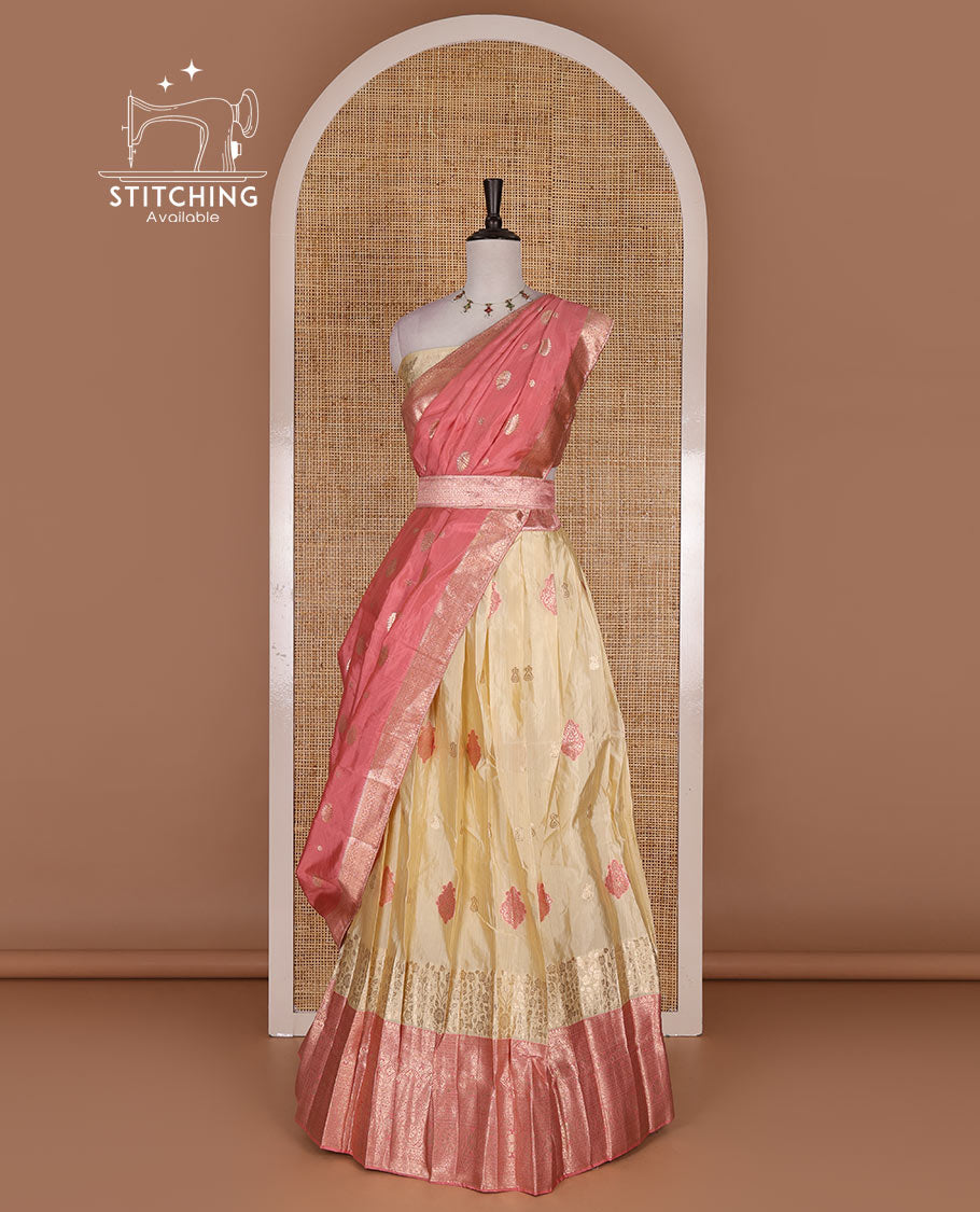 Cream taffeta silk half saree, meena buttas skirt, contrast pink traditional zari border, matching blouse, and zari woven dhavani