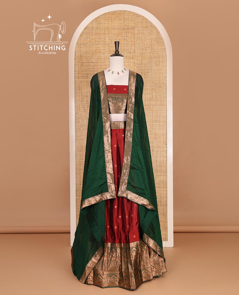 Maroon taffeta silk half saree, zari buttas with contrast green traditional zari border skirt, matching zari design blouse, and contrast plain zari border syska georgette dhavani