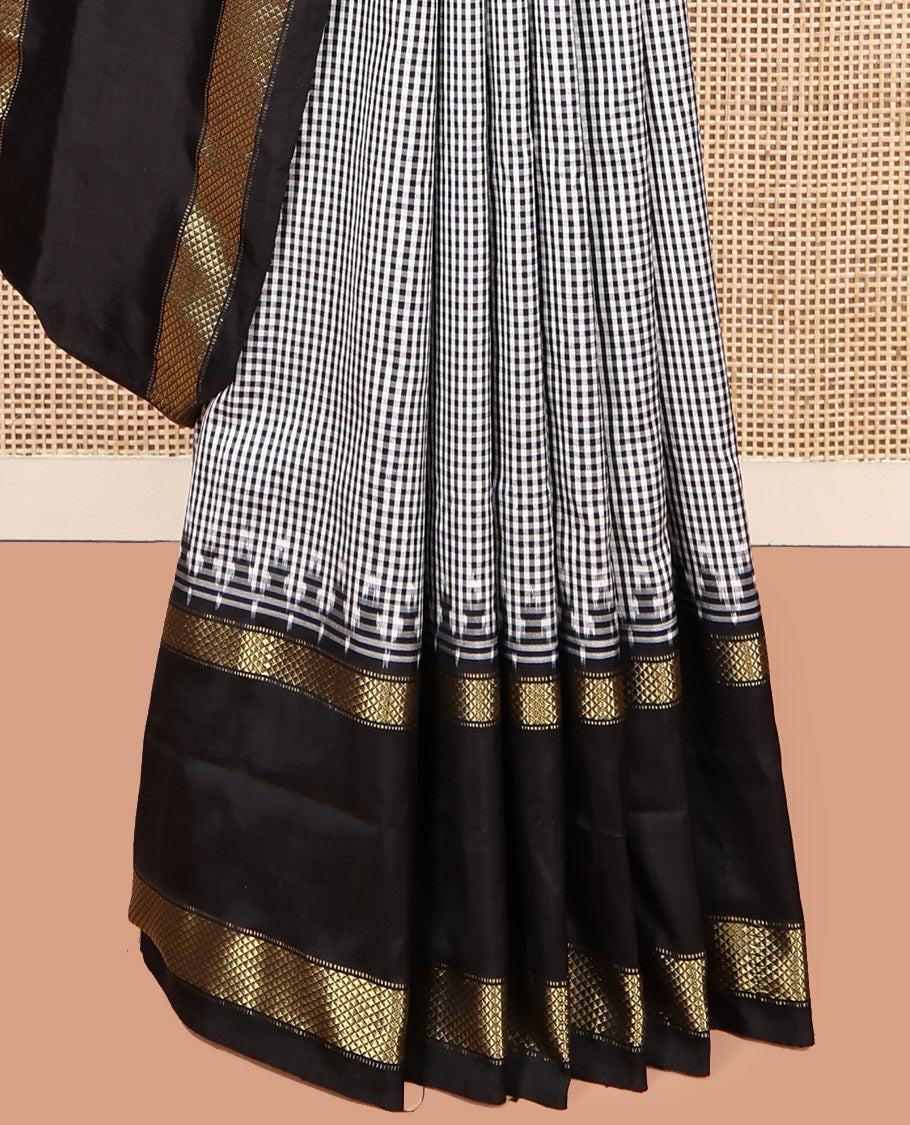 Black-White Micro-Checked Pochampally Ikat Silk Saree, Complemented by a Contrast Zari Cuckoo Bird-Eye Border, Ikat Jaal Pallu, and a Contrast Blouse