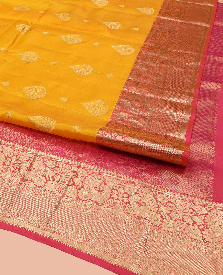 Yellow Vasundhara Lite Silk Mix Saree, Adorned with Zari Buttas All Over Its Body, Complemented by a Contrast Border of Thilakam Mokku, Muthu, Mayil, Kamalam, and Mayil Kann Designs, Gracefully Embellished Pallu, and Paired with a Contrast Blouse