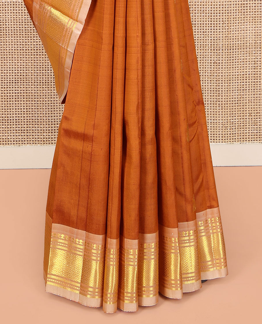 Rust Orange Kanchipuram Silk Saree, Bedecked with Zari Buttas on Its Body, Complemented by a Contrast One-Sided Border of Panner Sombu, Banaras, Muthu, and Mayil Kann Designs, Pallu of Zari Designs, and Comes Without a Blouse